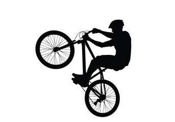 Fototapeta premium Bicycle stunt silhouette illustration. Person performing a wheelie on a bike. Extreme sport and balance concept.