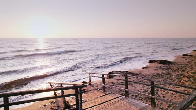 Ancient Stairs on Long Beach at Sunrise: Waves Kissing the Sand with Early Morning Light in Iskele