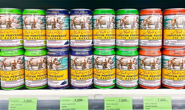 Jakarta, Indonesia - February 25th, 2026 - Larutan penyegar cap badak drink can container bottles isolated on horizontal store shelf background.
