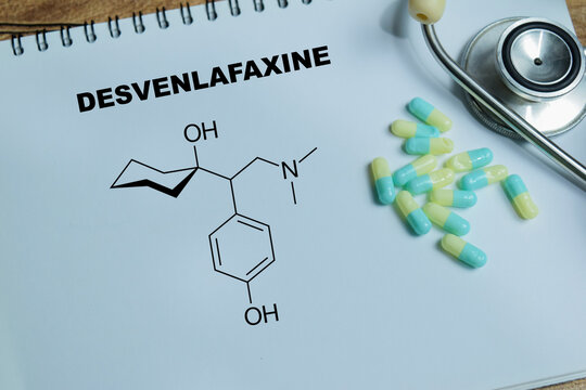 Concept of desvenlafaxine antidepressant medication write on book isolated on Wooden Table. SNRI treatment for depression and anxiety disorders