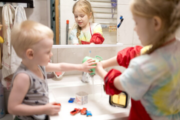 Children's games. Children playing in the sink.