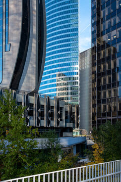 Modern abstract walkway and railing beside glass skyscraper facade architecture in Paris La Defense business district vertical towers