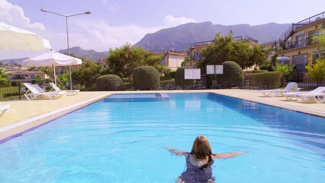 Drone Aerial Footage of Woman Swimming at Modern Luxury Villa on Holiday