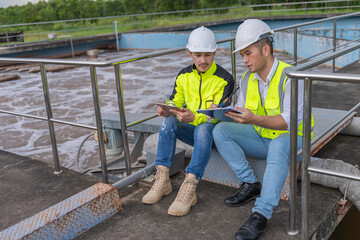 Fototapeta premium Environmental engineers work at wastewater treatment plants,Water supply engineering working at Water recycling plant for reuse