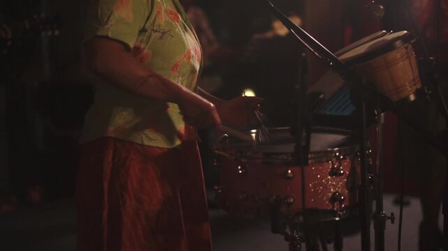 Close-up drummer playing drum in music concert or performance