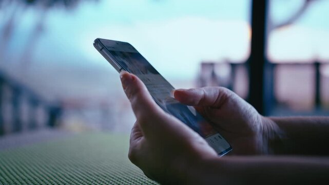 Young Woman Using Mobile Device for Social Media on Veranda with Beautiful Mountain View