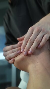 Caucasian woman receiving deep tissue facial mobilization from clinician