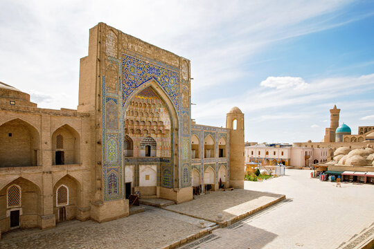 Kosh Madrasah complex in Bukhara with Ulugh Beg and Abdulaziz Khan Madrasas framing Toki Zargaron domes, historic Islamic architecture