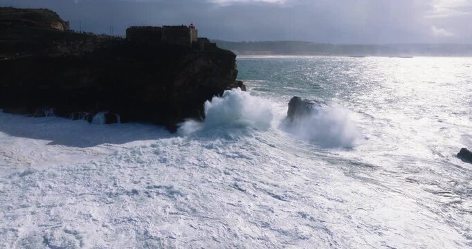 Wide view of turbulent shoreline at Nazar&eacute;, Portugal during stormy cloudy afternoon