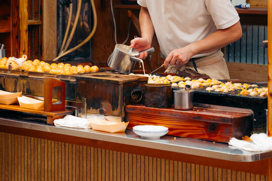 Osaka chef prepares takoyaki, a popular Japanese street food snack