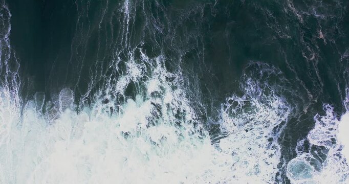 Storm swell rolling in long lines at Nazar&eacute;, Portugal during overcast afternoon