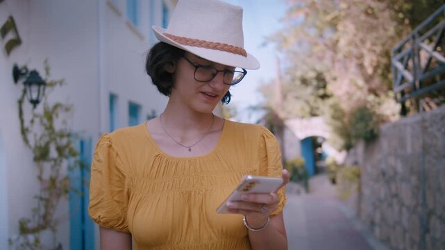 Fashionable Girl Using Smartphone for Social Media on Picturesque European Alleyway
