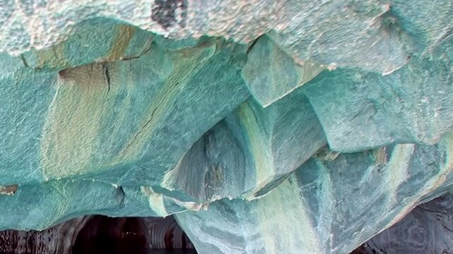 Marvel at vibrant hues within Patagonia's Marble Caves. Incredible azure and white rock formations, sculpted by nature, create artistic mosaic above clear waters. Unforgettable natural spectacle.
