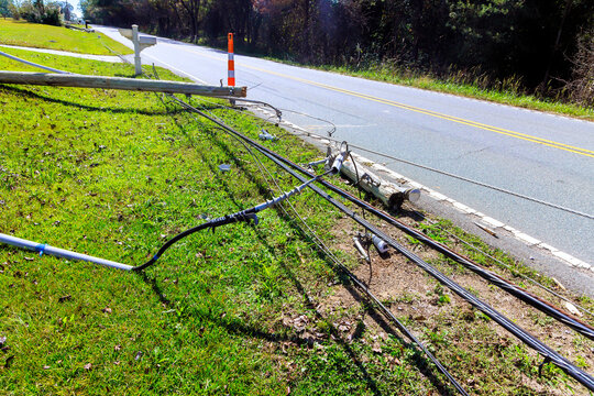 Power lines are seen downed next to road in rural area, causing a disruption to local utilities during tornado storm