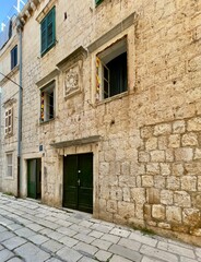 Fototapeta premium Croatia, Vis Island, street and old Dalmatian houses on a sunny summer day. The historic town of Vis on the island of Vis.