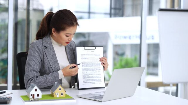 Asia business woman professional real estate sale agent talking explaining business contracts, lease agreements, loans and banks for new home purchase  via video call.