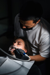 Patient Receiving Accurate Dental Work Under Dim Lighting By Skilled Professional With Tools © flywish