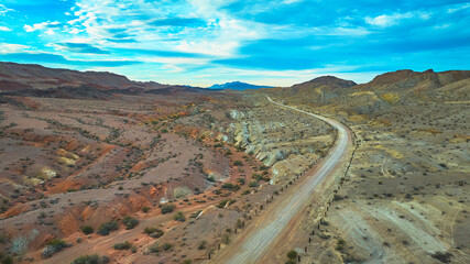 Aerial Desert Road and Rugged Hills near Las Vegas Nevada under Dramatic Sky