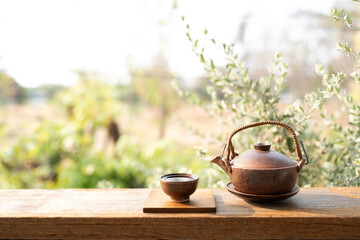 Old brown vintage tea cup and tea pot on wooden table