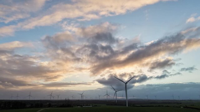 Sunset Hyperlapse Over Wind Farm in Irish Countryside &ndash; Aerial 4K 25fps