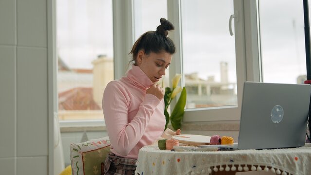 Female managing packaging and crafting at small business window