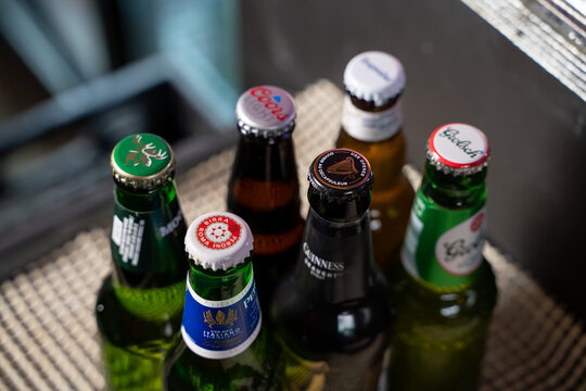 Top view of assorted beer bottles on table. Toronto, Canada - February 20, 2026.