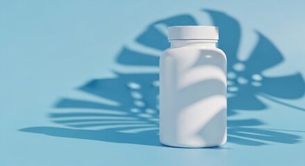 A small white bottle with a screw top lid on a blue background with a tropical leaf shadow