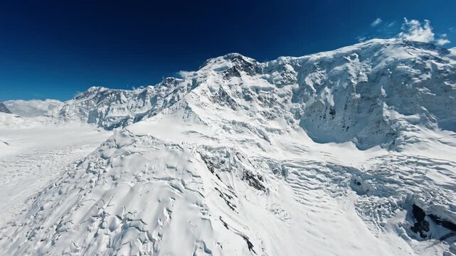 The foot of Pobeda Peak and the icefall. Drone flight in the mountains of Kyrgyzstan. 4K