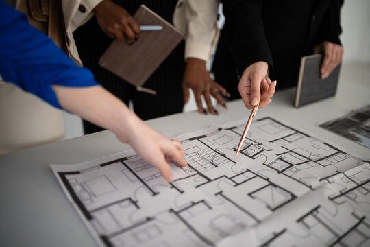 Architects collaborating on building floor plan design project