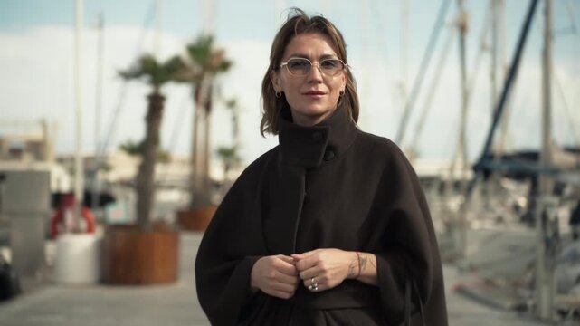 Stylish woman enjoying calm mindful moment by the sea. Concept of slow living, intentional lifestyle, emotional clarity and balanced modern travel.