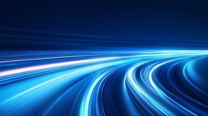 A vibrant blue abstract image of glowing light trails on a dark background with motion blur