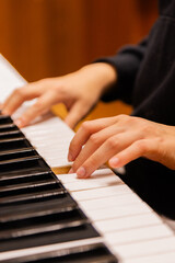 Fototapeta premium Close-up of a music performer's hand playing the piano. selective focus