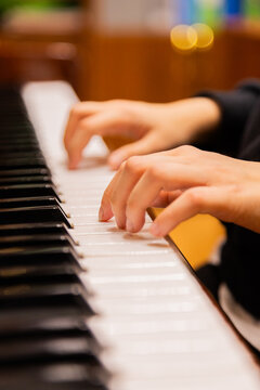 Close-up of a music performer's hand playing the piano. selective focus