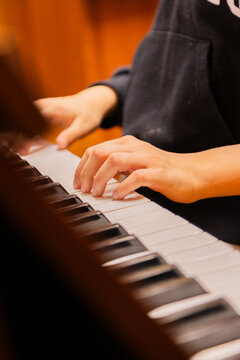Close-up of a music performer's hand playing the piano. selective focus