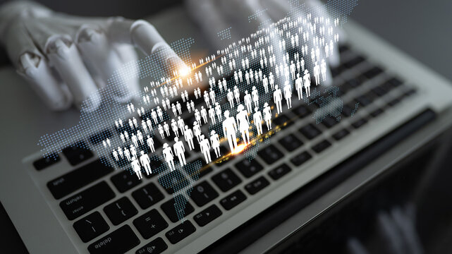 Futuristic Technology Concept Featuring Robotic Hand Interacting with Digital Human Icons on Laptop Keyboard in Modern Office Setting Quark.