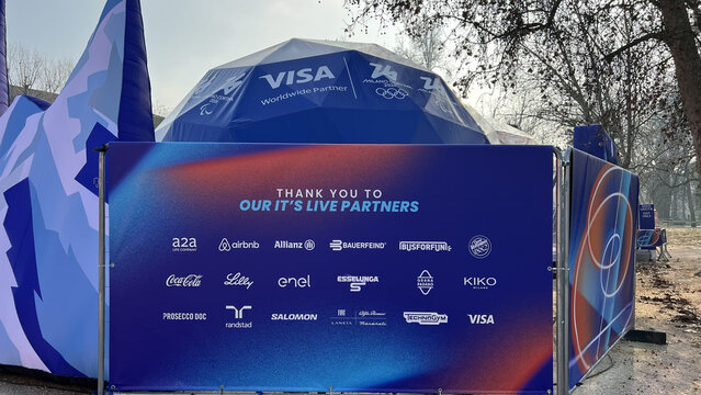Milan, Italy - February 24, 2026: Milano Cortina 2026 Olympic Village Visa dome with colorful sponsor board thanking official partners.