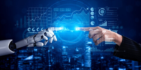 This image captures the intriguing interaction between a robot and a human hand, symbolizing the...