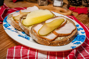 Sandwich with smoked chicken, cheese and pickled cucumber.