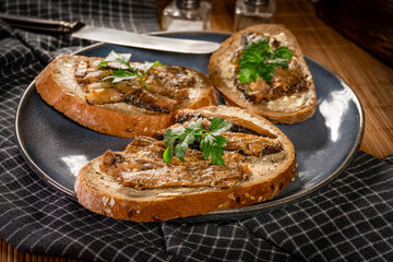 Slices of multigrain bread with sprats.