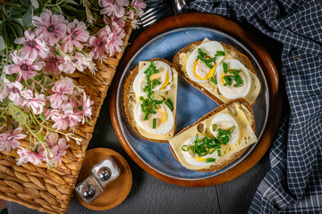 Sandwiches with yellow cheese, egg and chives.