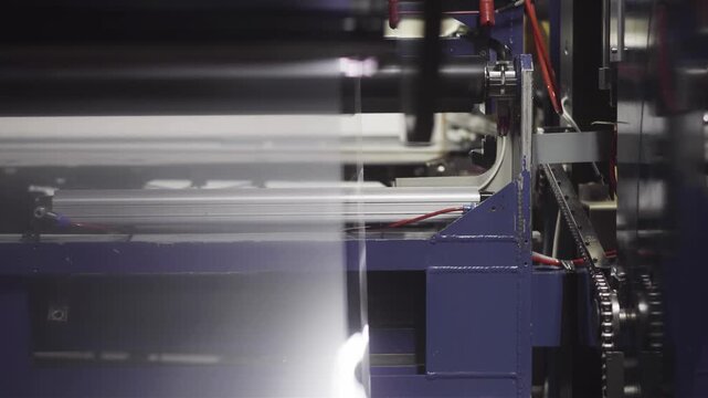 Industrial machine processing transparent plastic film on a production line
