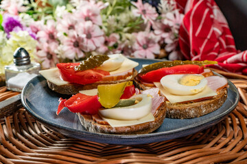 Sandwich with ham, eggs and tomato.