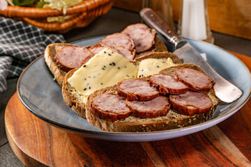 Sandwich with ham, eggs and tomato.