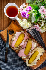 Sandwich with ham, cheese and pickled cucumber.