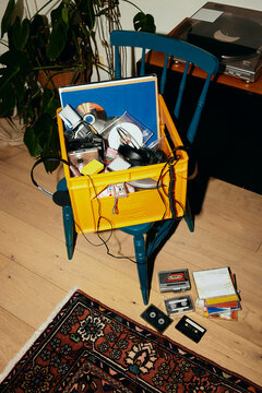 View of crate full of old music CDs and photographic equipment