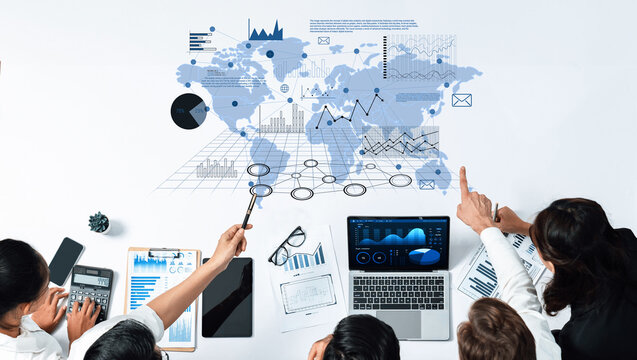 A business team collaborates to analyze global data and statistics displayed on a world map. Utilizing technology, they strategize for future growth and insights. Trope