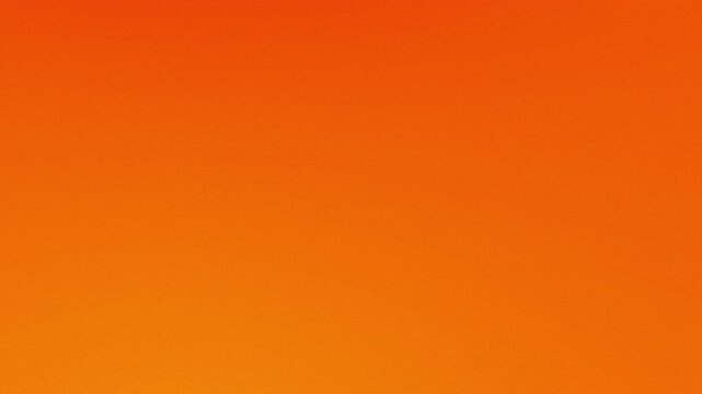 Vivid Orange Background: A striking, seamless gradient of orange, offering a bold and versatile canvas for various creative applications and concepts.