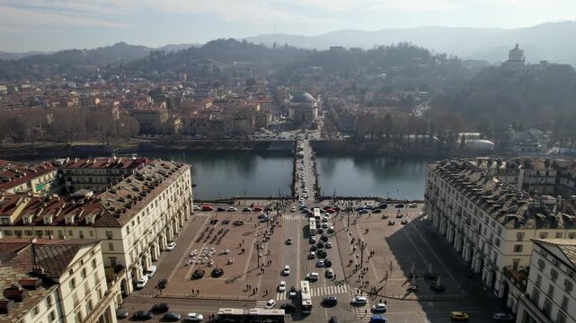 Aerial drone shot reveals the broad Piazza Vittorio Veneto leading to the Po river and Gran Madre di Dio church in Turin, Italy, historic urban architecture, city panorama, drone perspective.