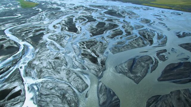 Amazing drone flight over an abstract braided river system flowing through volcanic sediment in Iceland