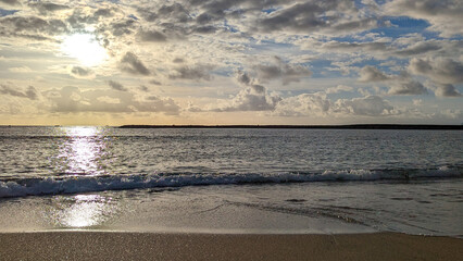 Fototapeta premium Beautiful sunset. Surf waves on Playa de las Americas sandy beach. Tenerife, Canary Islands. Spain.